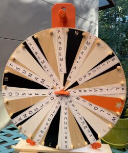 Orange and birch wheel with disaster types (earthquake, tsunami, wildfire etc) pasted on it